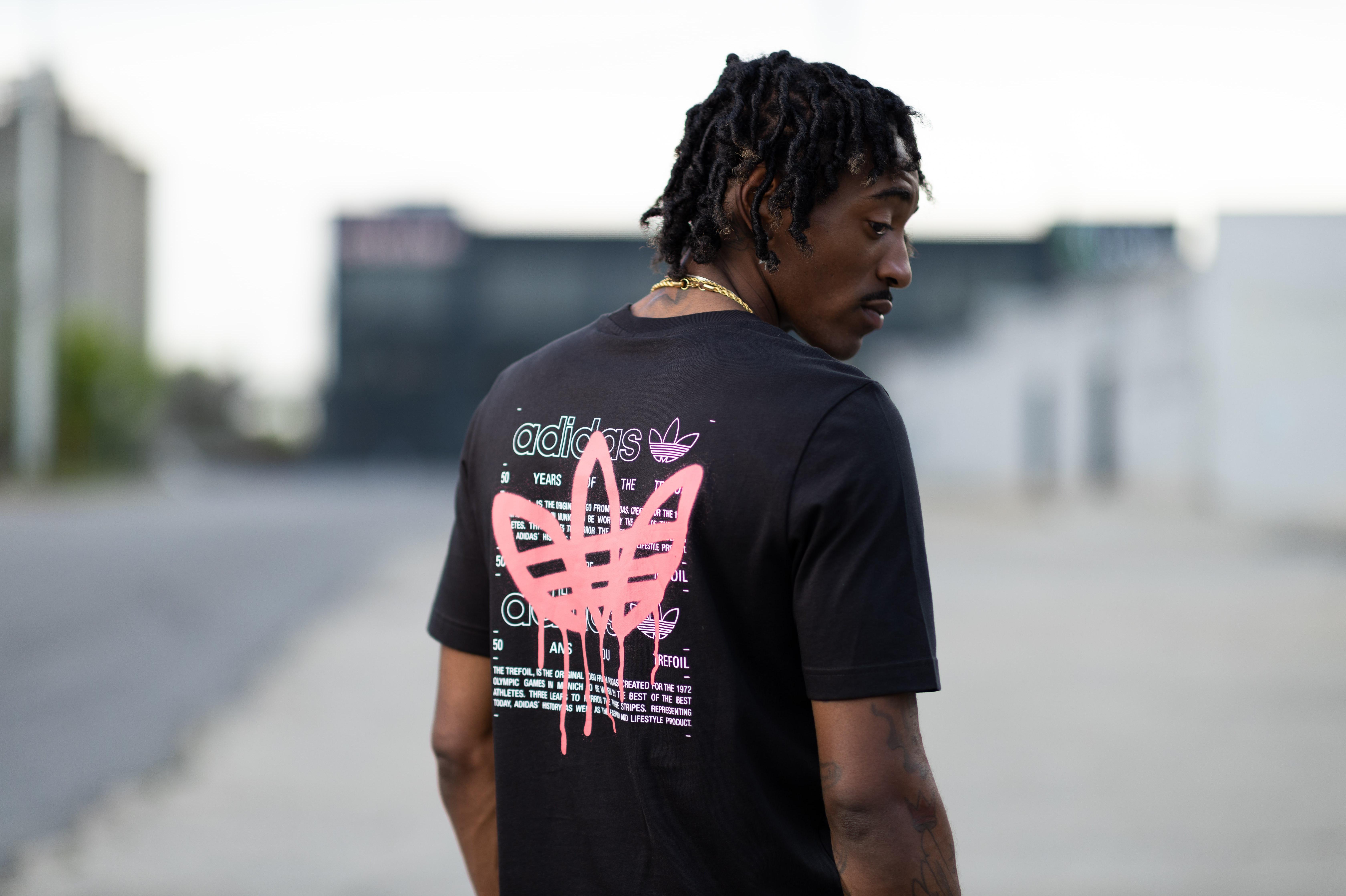 Man is black adidas shirt